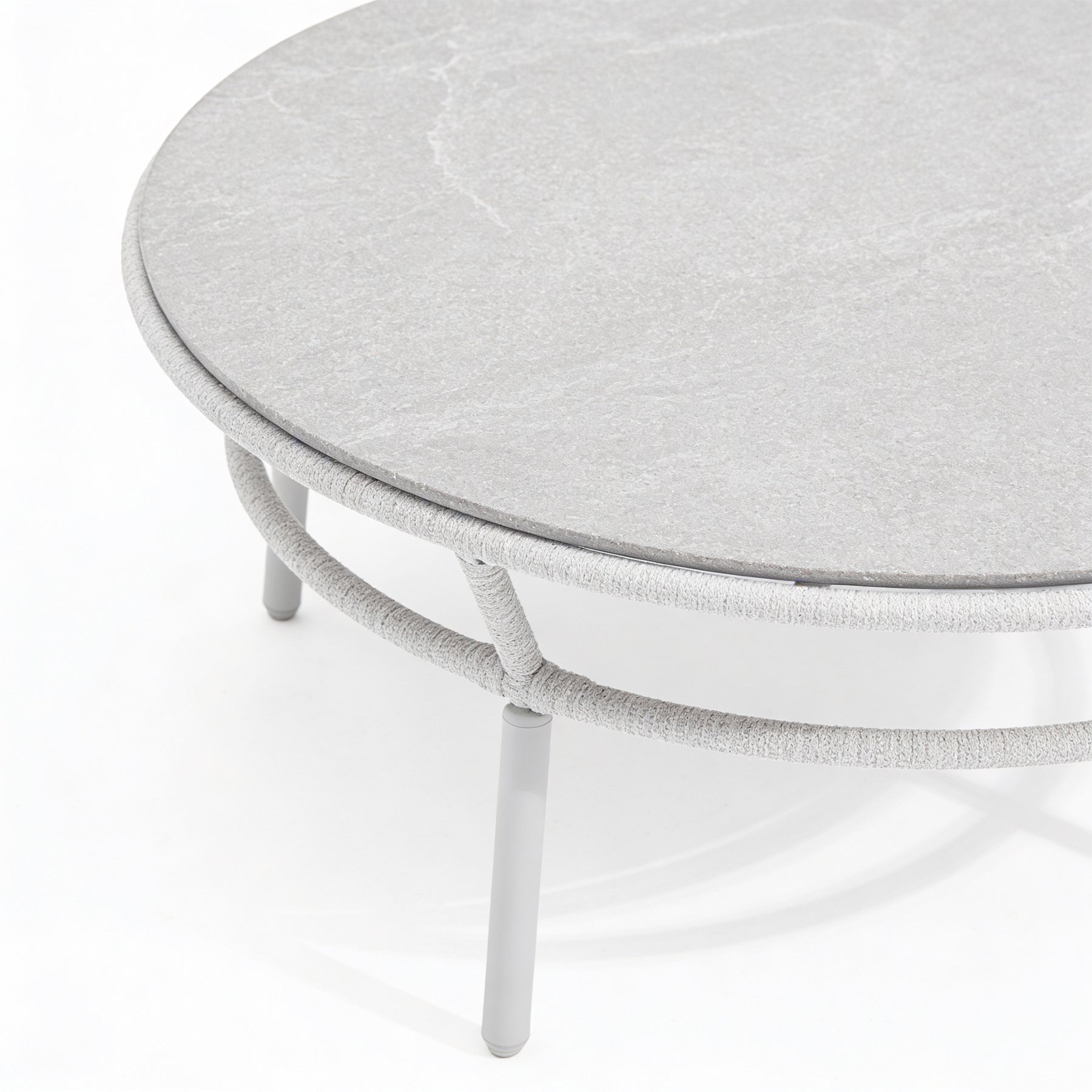 Round gray table with a textured surface on a white background