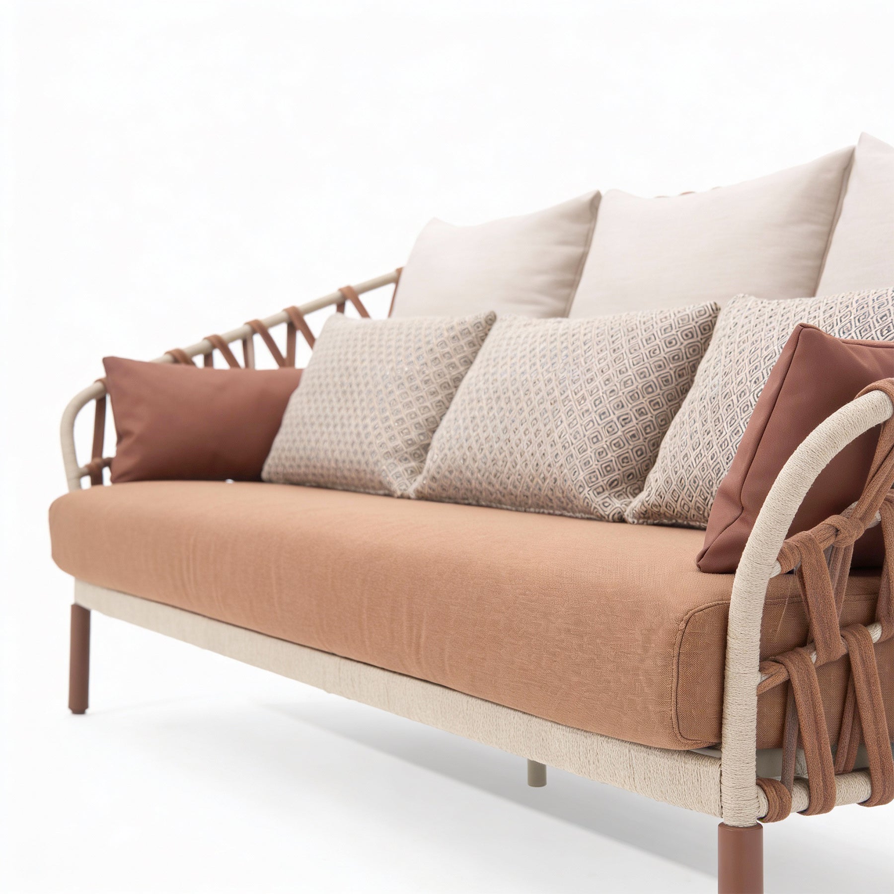 Brown and beige sofa with patterned cushions on a white background