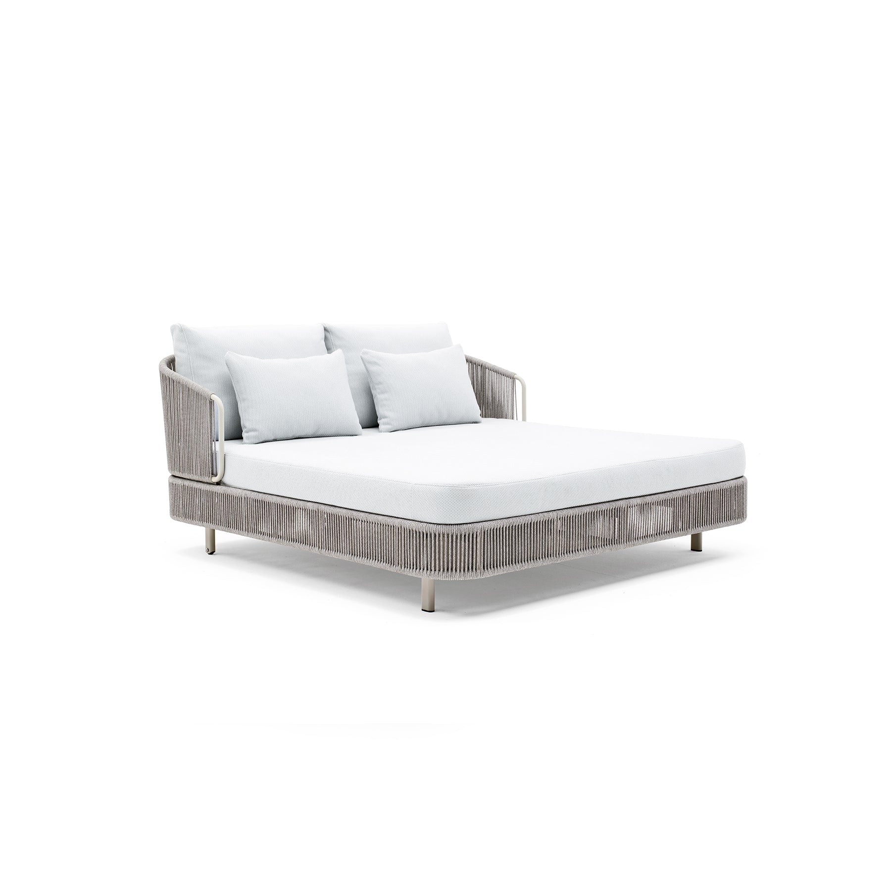 Outdoor sofa with wicker frame and white cushions on a white background