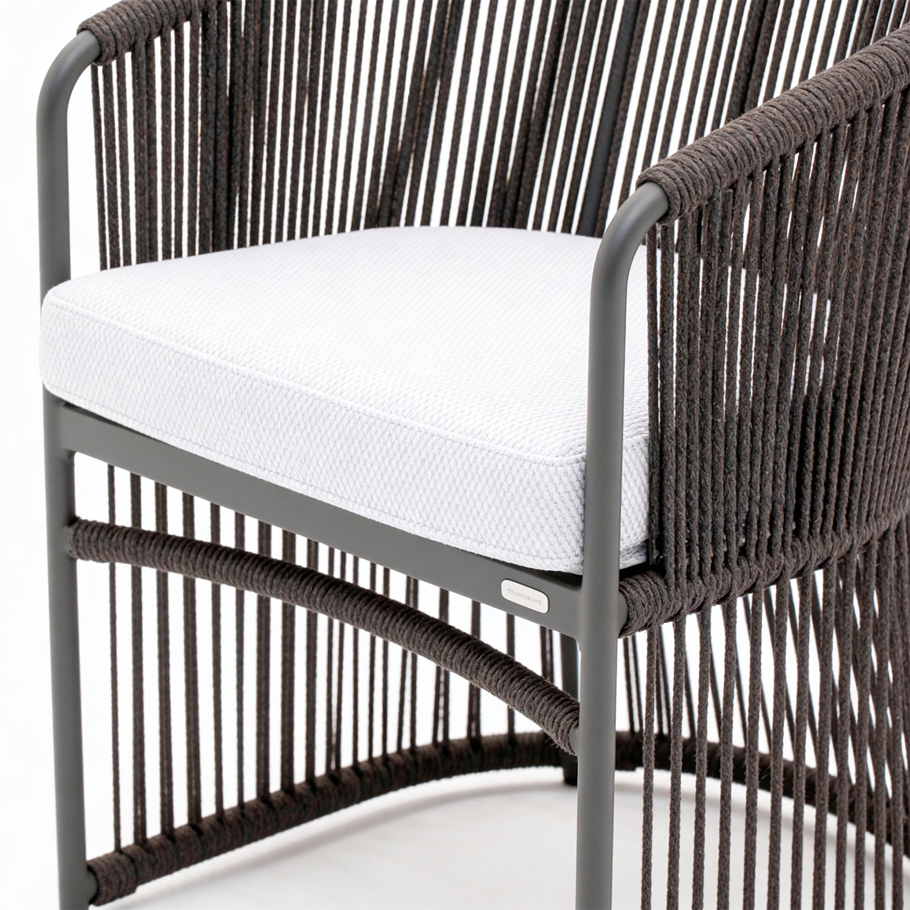 Chair with woven backrest and white cushion on a white background