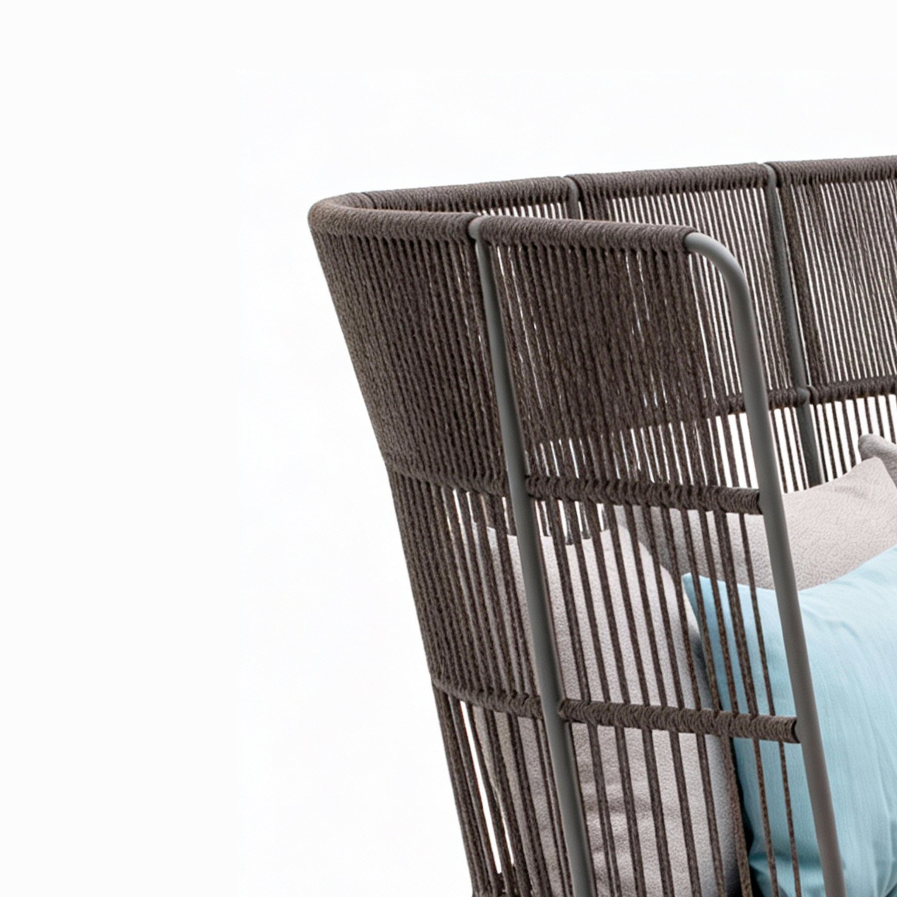 Wicker chair with a cushion on a white background