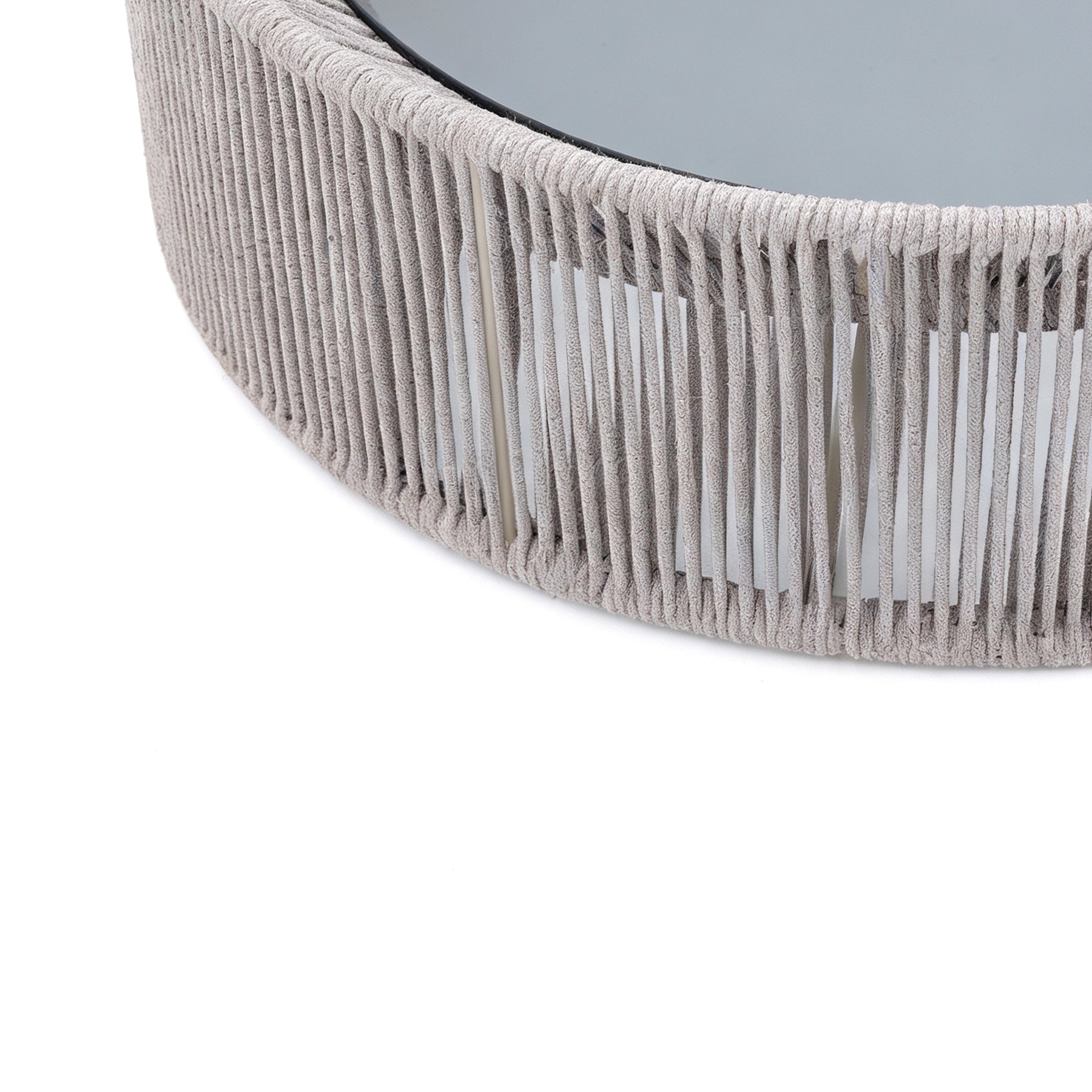 Close-up of a textured round mirror with a gray frame on a white background