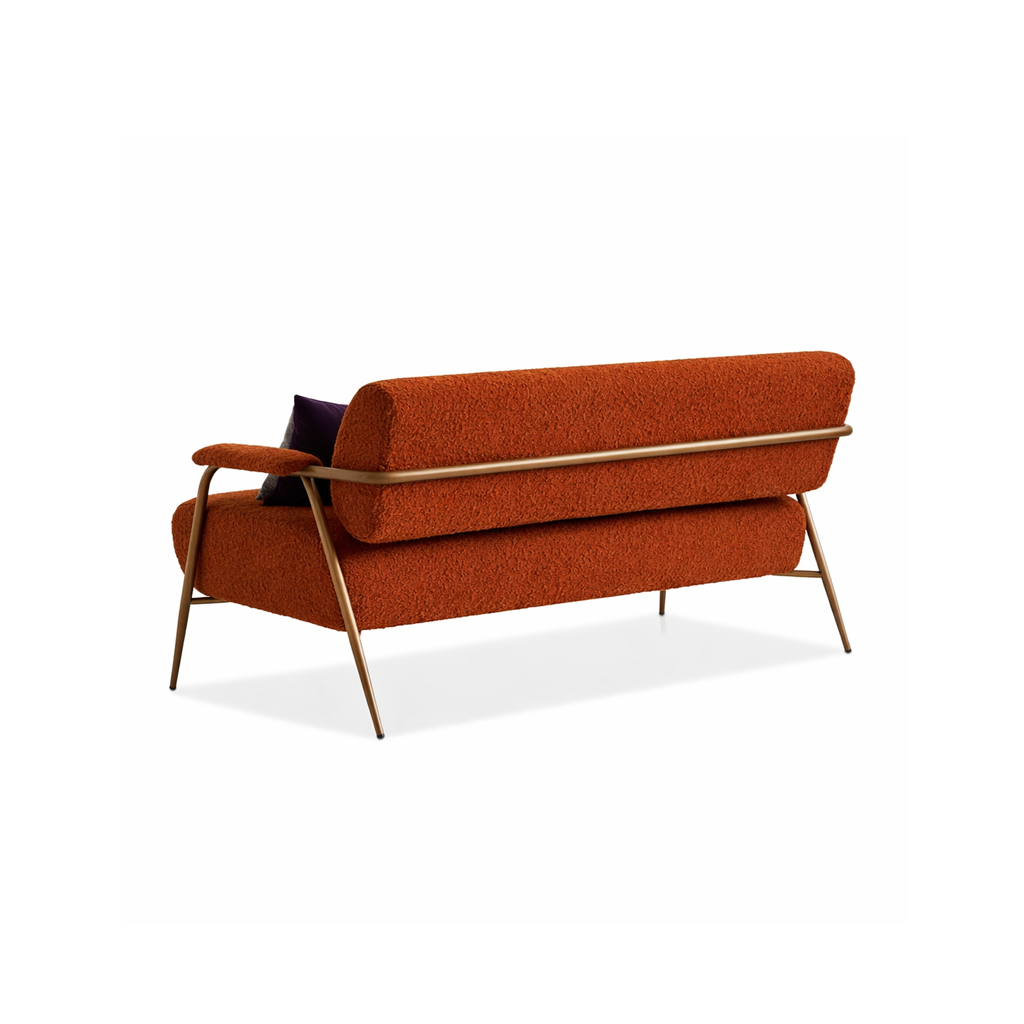 Orange sofa with gold metal legs on a white background