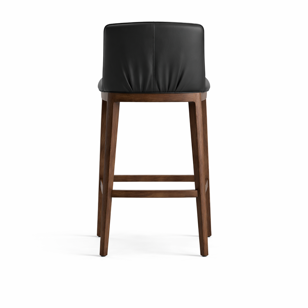 Bar stool with black cushioned seat and wooden legs on a white background