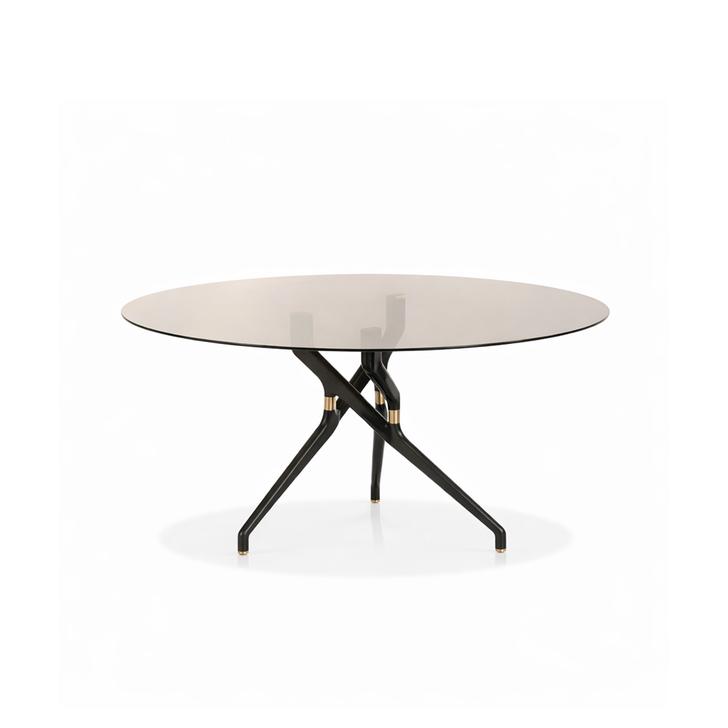 Round table with a metallic surface and black metal legs on a white background