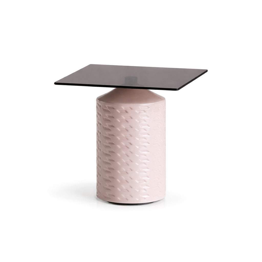 Small table with a textured pink base and dark glass top on a white background